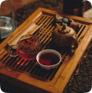 Tea set on wooden tray with teapot.